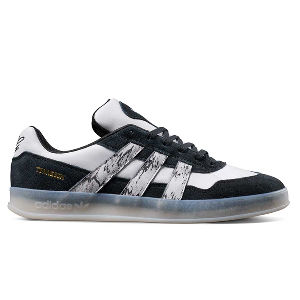 The JR7101 Gustav Tonnesen Black White Aloha Super Suede Leather Skateboarding Shoes feature a black and white design, translucent sole, marbled white stripes, gold "SPZL" near the heel, and are built for skateboarding performance.