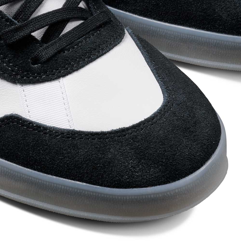Close-up of the JR7101 Gustav Tonnesen Black White Aloha Super Suede Leather Skateboarding Shoes, featuring a white upper, black suede overlays, black laces, and a semi-translucent gray sole—perfect for skate fans.