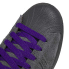 Close-up of the JR7409 Carbon Purple Superstar ADV Adidas Suede Skateboarding Shoes, with a textured black rubber toe cap, bright purple laces, and a premium carbon purple suede finish.