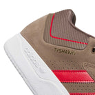Close-up of the JR9499 Earth Color Tyshawn Adidas Skateboarding suede skate shoes, featuring beige uppers with red stripes, white cupsole, gold TYSHAWN text, and a brown heel panel with a red accent. Part of the Tyshawn Jones skate line.