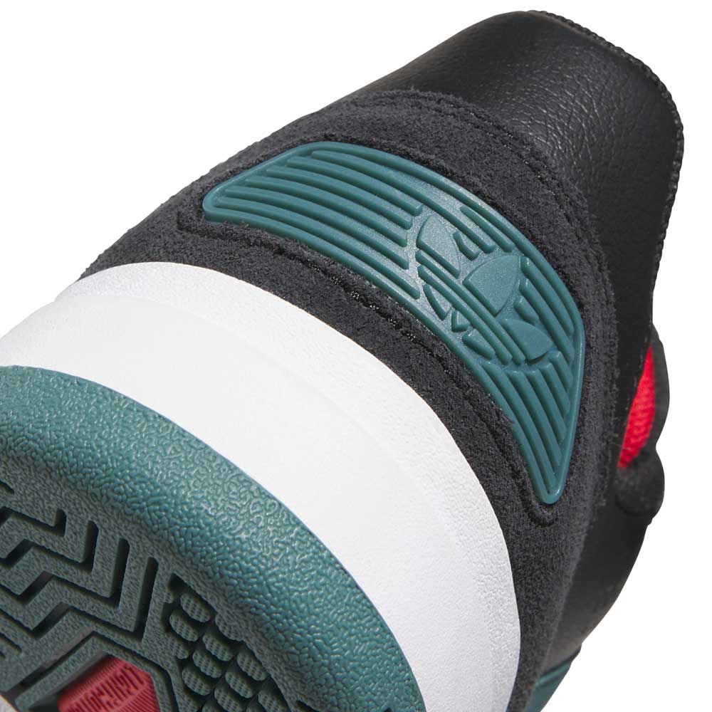 Close-up of the heel on the JS4307 Core Black Preloved Teal Better Scarlet Tekkira Suede Leather Adidas Skateboarding Shoes, showing textured teal, white, and black materials, a raised teal emblem with red detail, and patterned cupsole grip.