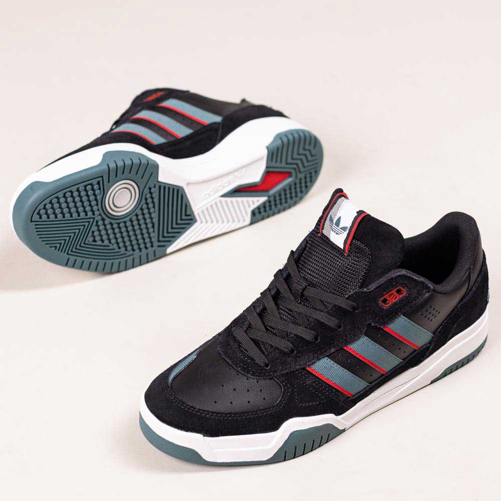 The JS4307 Core Black Preloved Teal Better Scarlet Tekkira Suede Leather Adidas Skateboarding Shoes feature black suede and mesh, teal and red accents, white soles, and a grippy cupsole. One shoe stands upright; the other shows the sole’s pattern.