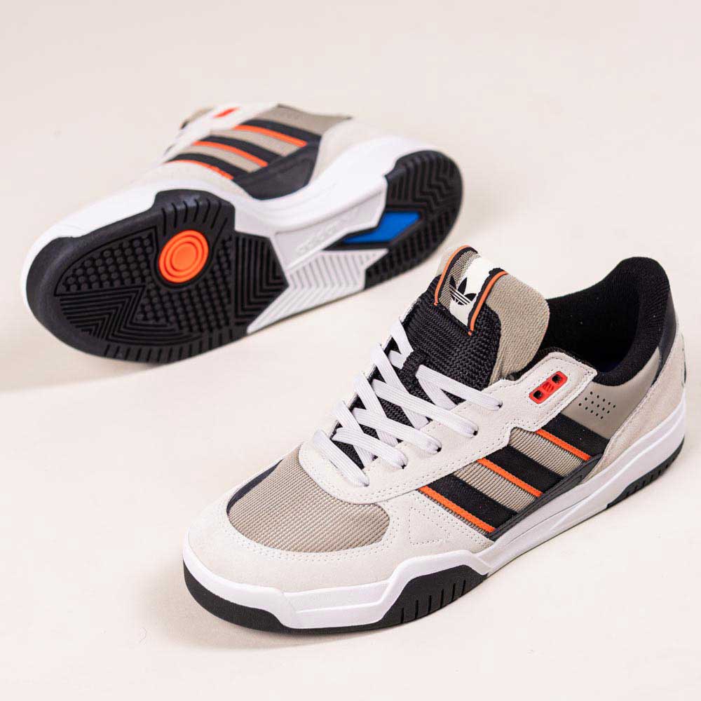 A pair of JS8906 Orbit Grey Core Black Solar Red Tekkira suede leather Adidas skateboarding shoes—one upright showing the side and top, the other flipped to highlight the sole and cupsole comfort.