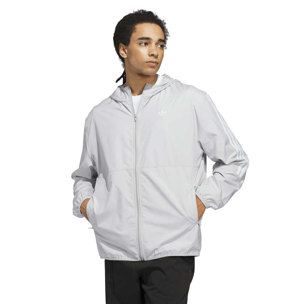 Person wearing a light gray jacket on a white background