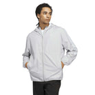 Person wearing a light gray jacket on a white background