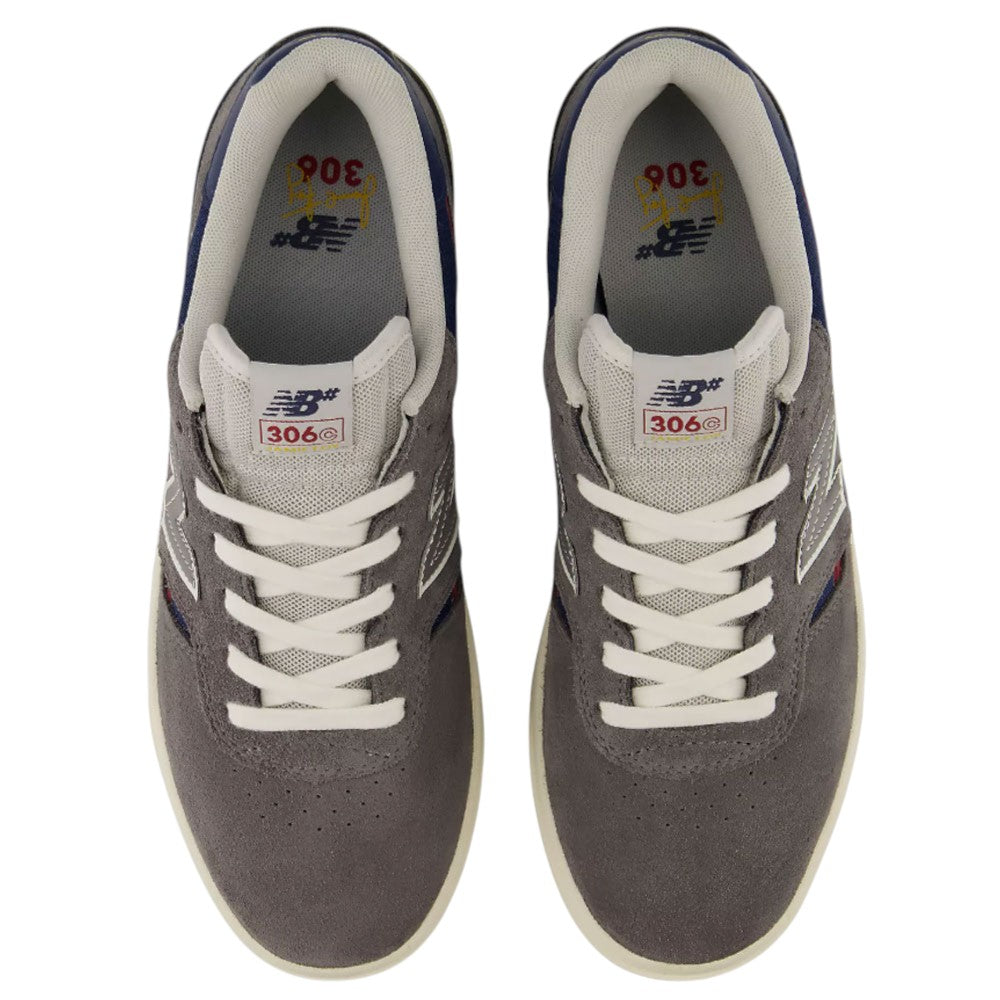 Top view of a pair of gray Jamie Foy Cup 306 CON New Balance Numeric Suede Skateboarding Shoes featuring white laces, white and navy trim, and New Balance branding on the tongues and insoles. These durable suede skate shoes include a rubber cup outsole designed for superior grip and board feel. The shoes are positioned side by side on a white background.