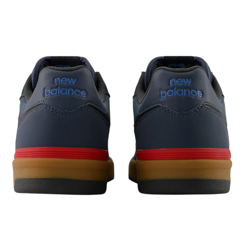 Back view of two navy blue Jamie Foy Cup 306 CON New Balance Numeric Suede Skateboarding Shoes featuring red midsole accents and gum rubber outsoles.