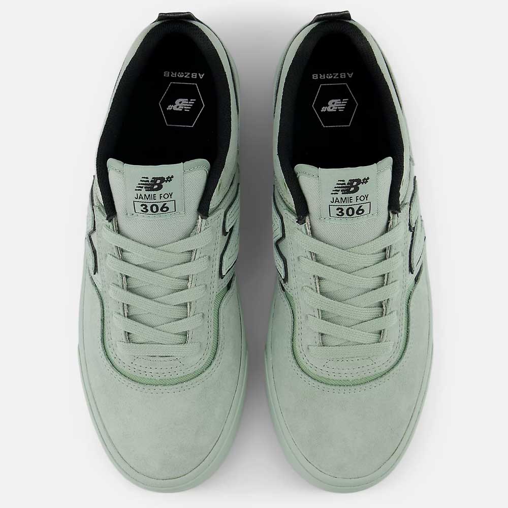 A top view of the Mosaic Green Black Jamie Foy Mint 306 MOG New Balance Numeric suede skateboarding shoes with white laces, black interior lining, "JAMIE FOY 306" on the tongue, and hexagonal insole branding.
