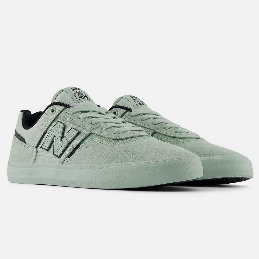 A pair of Mosaic Green Black Jamie Foy Mint 306 MOG New Balance Numeric Suede Skateboarding Shoes with a large N logo and low-top vulcanized design—ideal for skateboarding, showcased on a plain white background.