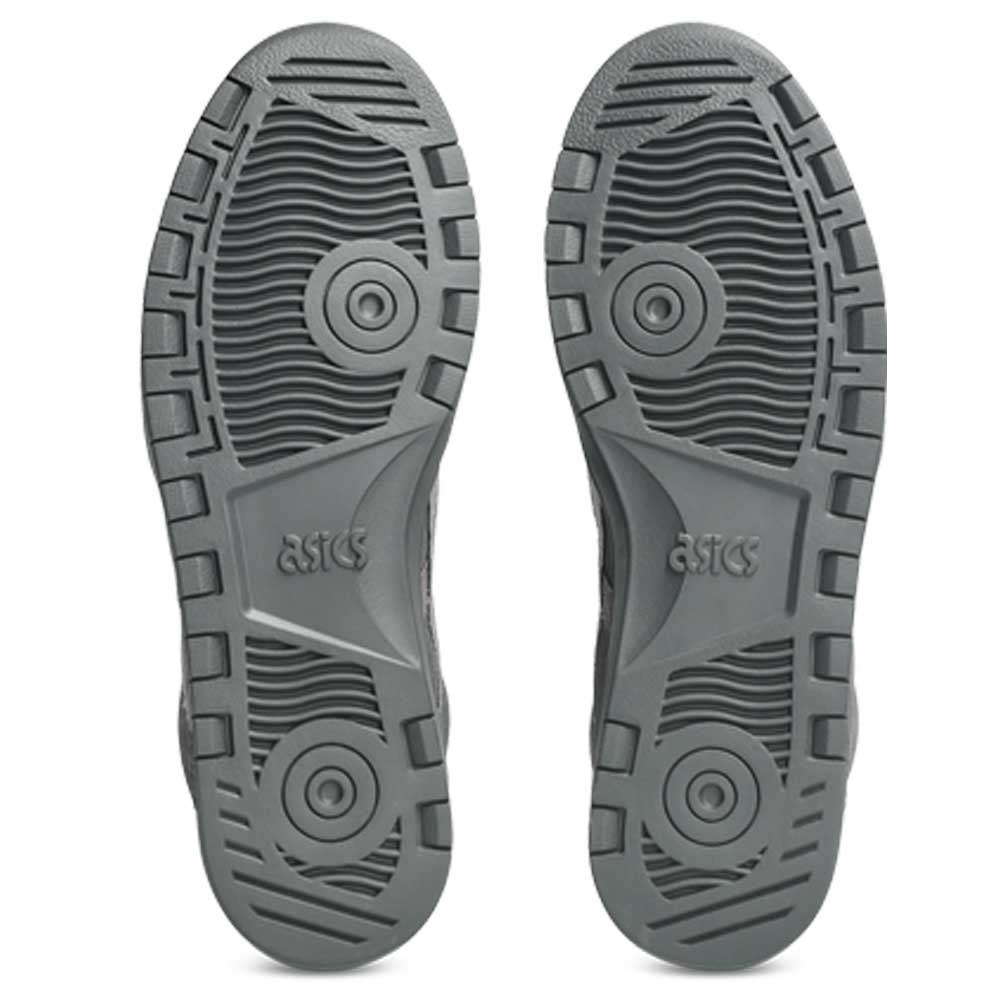 The image shows the soles of Japan Pro MT ASICS Graphite Gray Cay Red 1203B088 021 suede skateboarding shoes, featuring a textured tread with geometric and circular patterns and the ASICS logo centered on each sole.
