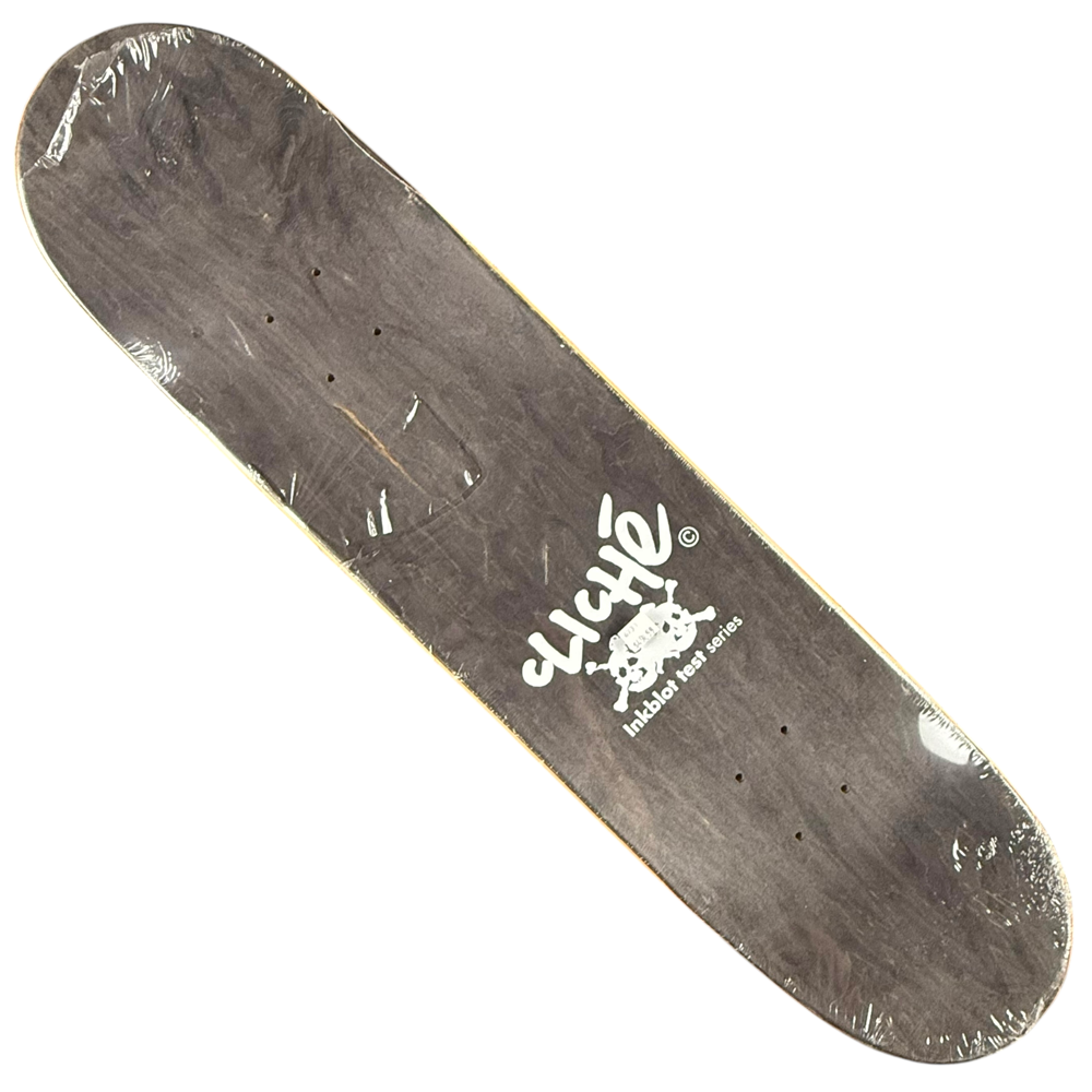 The Javier Mendizabal Inkblot Cliche Deck 8x31.9 Collectible is a wooden skateboard deck with a black finish, white Cliché logo, and skull graphic, packaged in clear plastic.