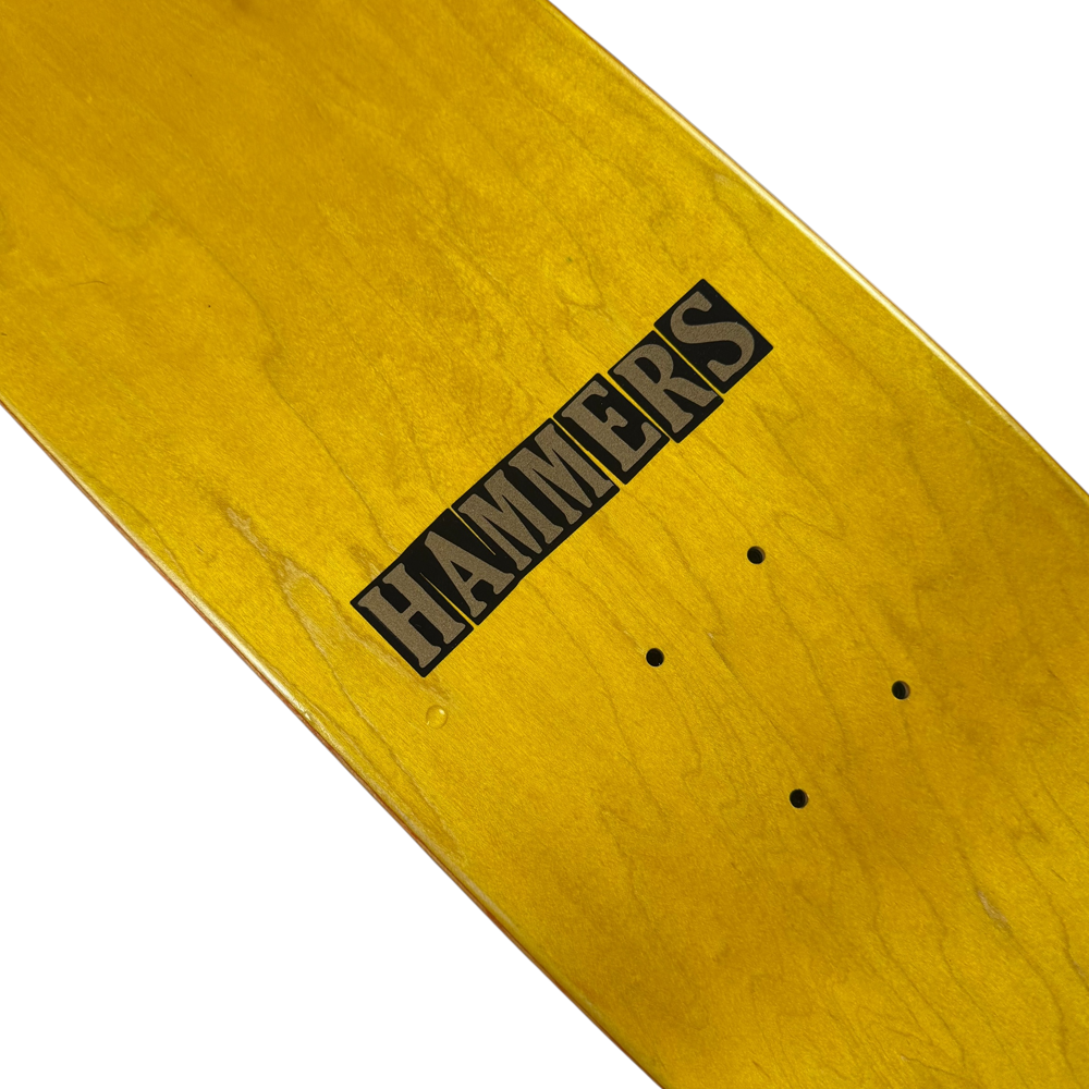 A close-up of the Jim Greco Hammers 3 Board Deck Set Collectible shows its bold, yellow design with "HAMMERS" in black and four drilled holes, making it a standout limited edition for skateboard enthusiasts.