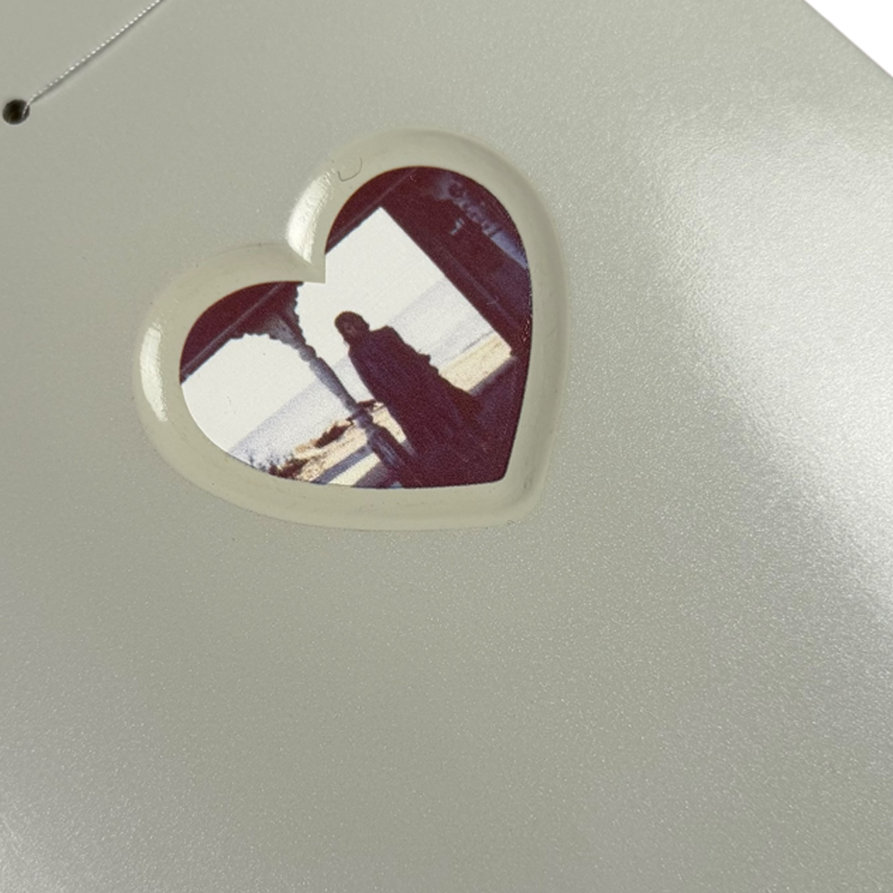 A heart-shaped cutout in the metallic Jim Greco Hammers 3 Board Deck Set reveals a faded photo of a person outdoors, evoking the unique collectible art style seen on limited edition skateboard decks.
