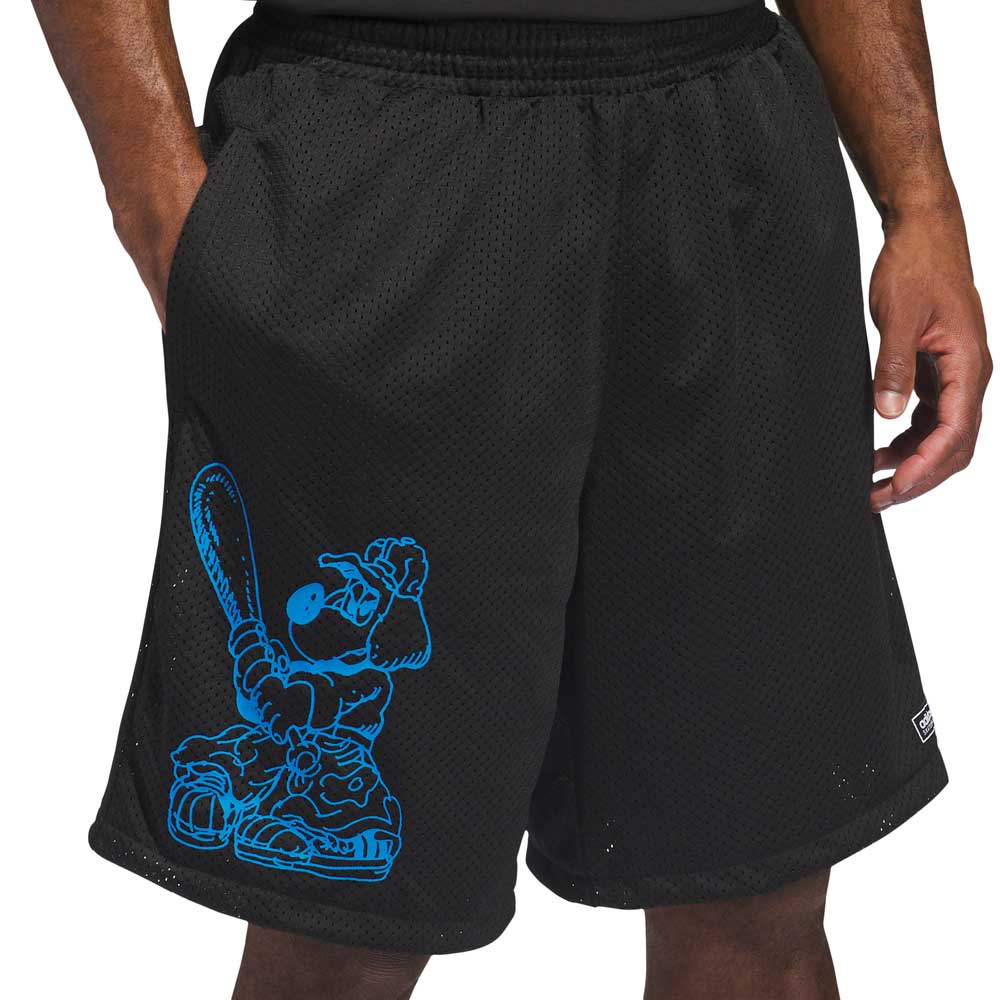 A person wears KC6308 Kogan Shorts Blue Black Adidas Skateboarding, featuring a blue cartoon baseball player with a bat on one leg. Their hands in the pockets emphasize the cool skate style.