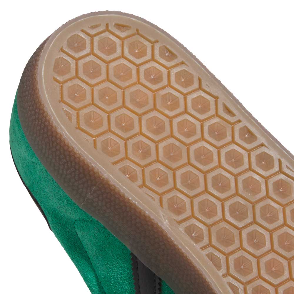 Close-up of the KI3206 Green Black Gazelle ADV Adidas Skateboarding Suede Shoes, showcasing a light brown rubber sole with a hexagonal grip pattern—ideal traction for daily adventures.