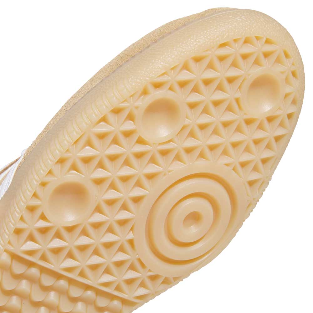 Close-up of the beige rubber sole on KI5089 Tan White Samba ADV Adidas Skateboarding Suede Shoes, showing a textured pattern with raised circles and small triangular grips for traction—ideal for skateboarding.