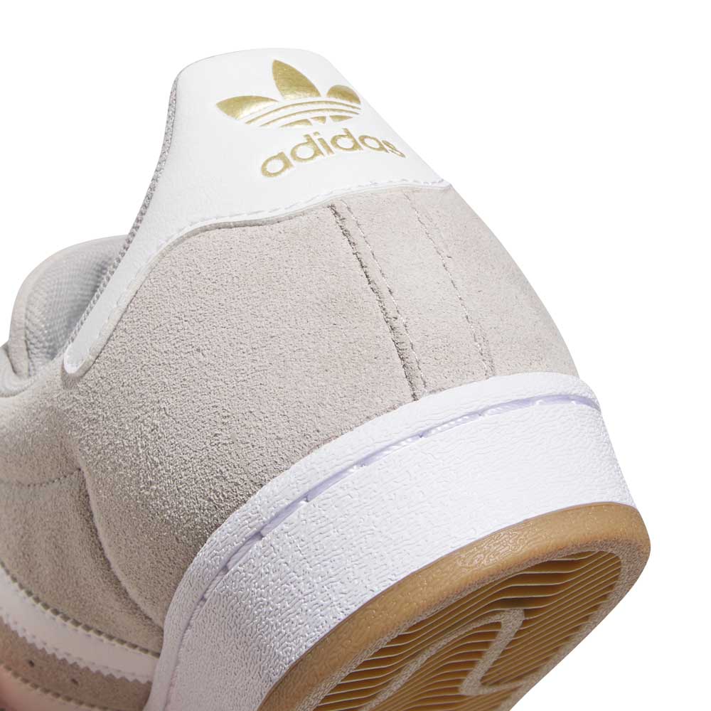 Close-up of the KI5733 Gray White Superstar ADV Adidas Skateboarding Suede Shoes, featuring a light beige upper, white heel tab with gold adidas trefoil logo, white midsole, and tan outsole—blending style and performance for skaters.