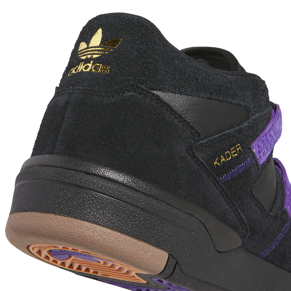 Close-up of a Kader Black Purple KI0408 Adidas Skateboarding Suede Leather shoe, showing a durable black suede and leather heel with gold branding, the name KADER on the side, a purple strap, and a gum-colored rubber outsole.