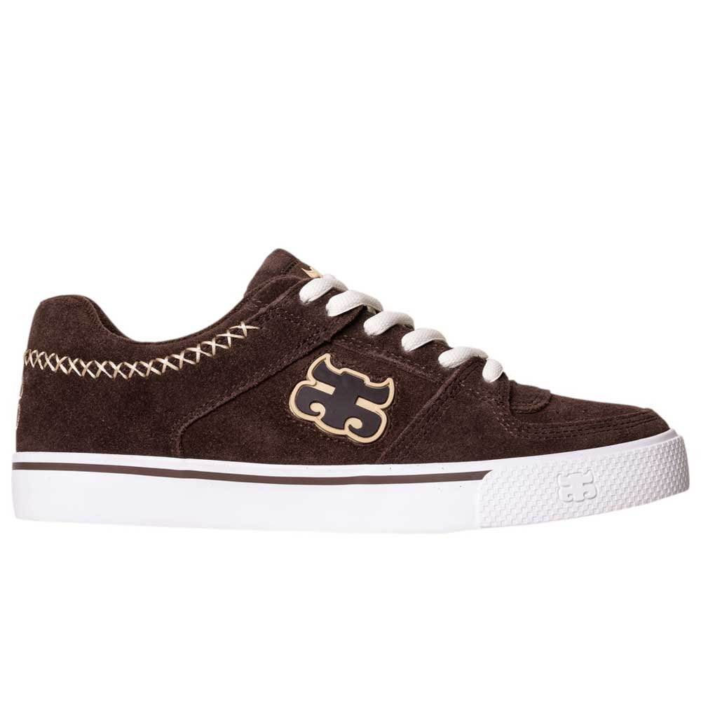The Kenny Reed Low Vulc Brown Suede I Path Shoes feature white stitching, laces, a white rubber sole, and a puzzle piece logo—offering stylish and functional skateboarding footwear for everyday wear.