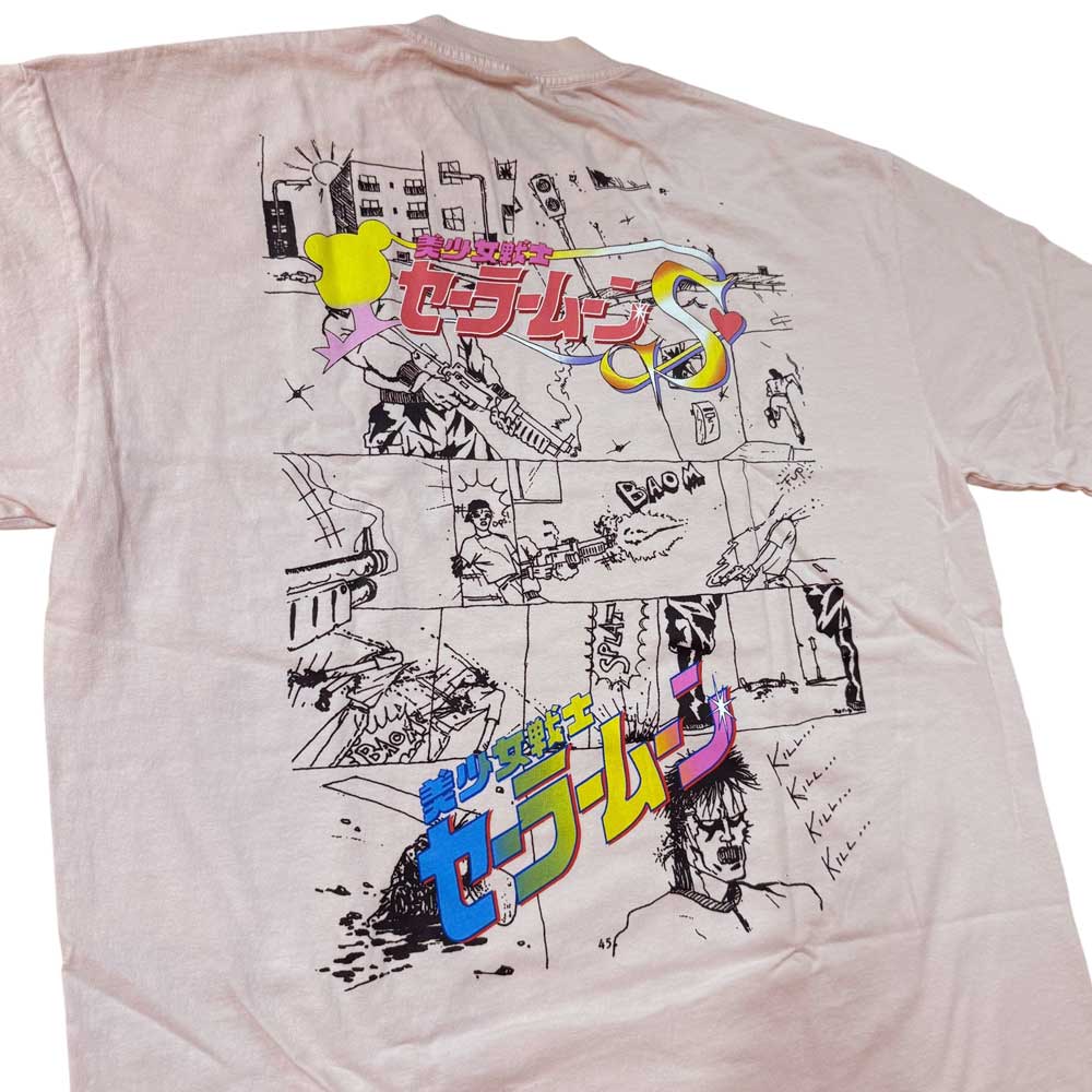 The Kill Kill Kill Light Pink Tee Paradise is a pre-shrunk, garment-dyed shirt featuring black-and-white comic-style panels, colorful Japanese text, Sailor Moon branding in Japanese and English, and illustrated characters with cityscape elements.