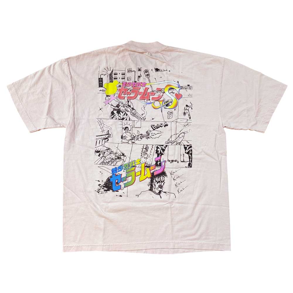 The Kill Kill Kill Light Pink Tee Paradise is a soft USA cotton garment-dye t-shirt in light pink, featuring black line art and colorful Japanese text on the back, with sketches of characters, buildings, and scenes from Sailor Moon.