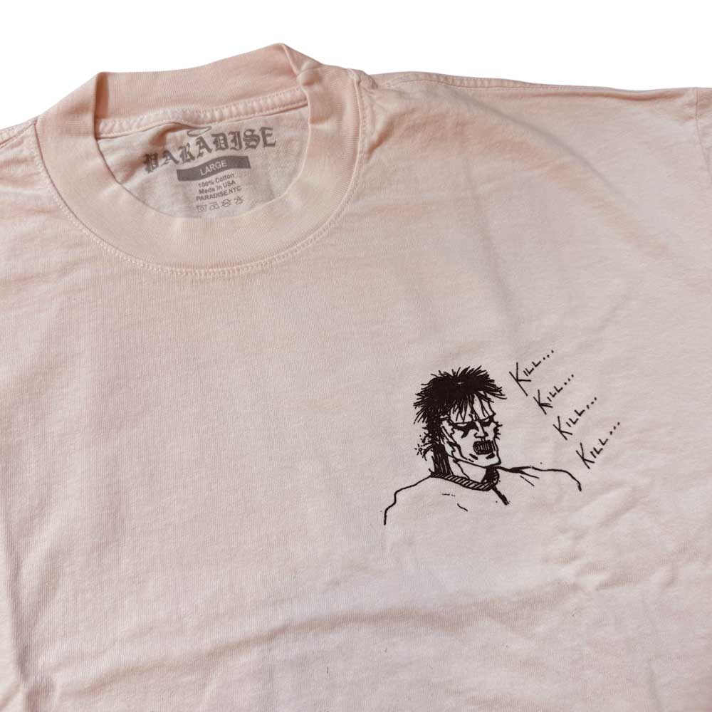 The Kill Kill Kill Light Pink Tee Paradise is a USA cotton, garment-dyed shirt in light pink, featuring a black line art of a serious man’s face and repeated "Kill... Kill... Kill..." text by the chest, with a “PARADISE” label.