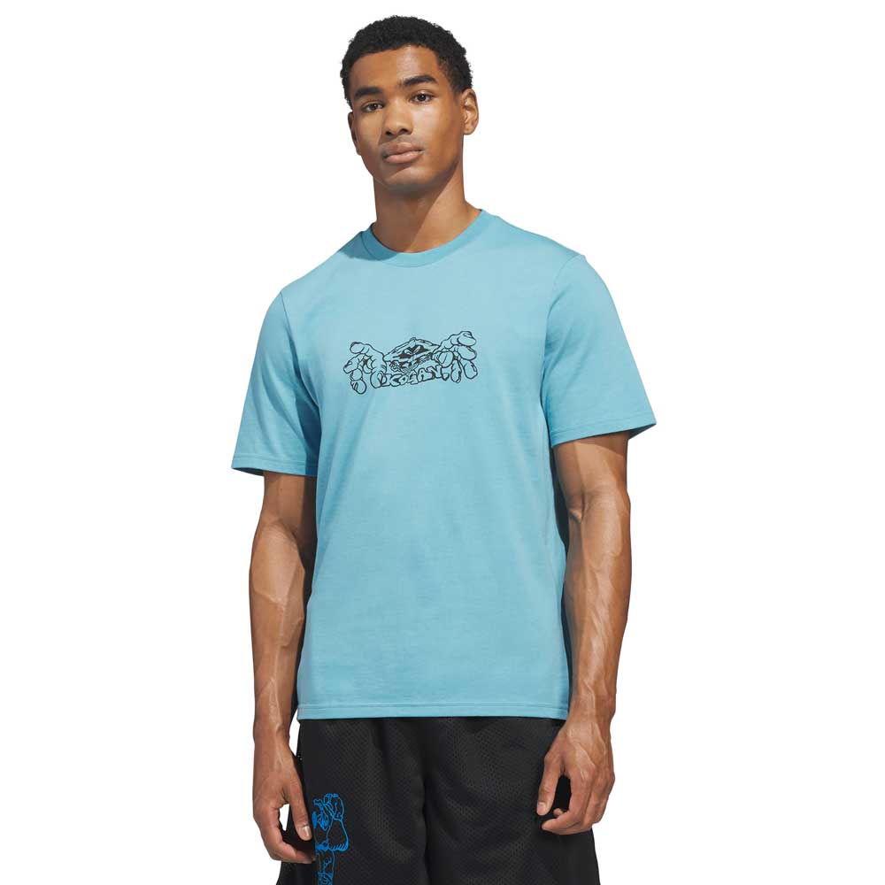 A man stands facing forward against a plain white background, wearing the Kogan Logo Tee Blue Black KC6301 Adidas Skateboarding and black shorts.
