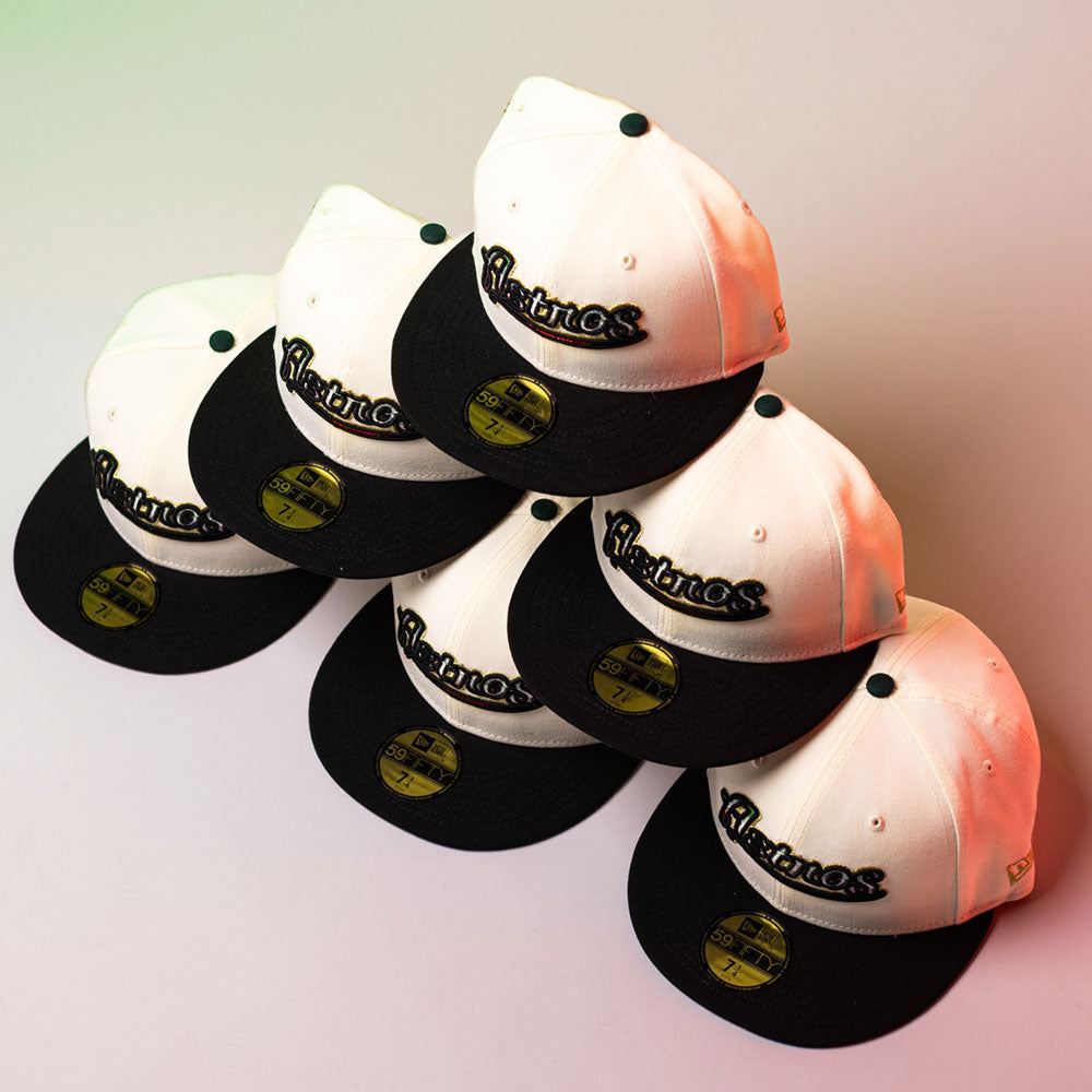 Six La Cumbia WS05 Chrome Black Mexico Houston Astros New Era Hat 5950 Fitted caps are stacked in a pyramid, each featuring a gold sticker on the brim and the Astros logo embroidered on the front in bold Chrome Black.