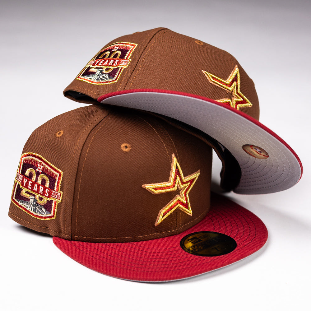 Two Bendicion de la Abuela 20th Brown Red Houston Astros New Era Hat 5950 Fitted hats, with a gold star and 20 YEARS patch, are stacked on a white background.