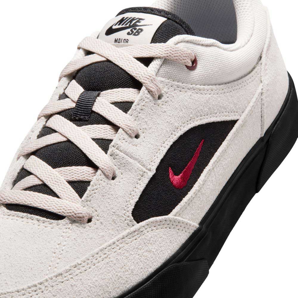 Close-up of a Light Orewood FV6064104 Malor Nike SB shoe with black details, red swoosh, and black laces/sole. The tongue displays the Nike SB logo—durable skate shoes ideal for kids.