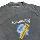 The Lightning Gold Bolt Tee Gray Income Taxes is a gray t-shirt made from premium USA cotton, featuring "incometax" text, a yellow screw and blue lightning design, with the label reading "incometax" and "MEDIUM.