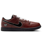 A side view of the HJ4131-200 Limosine Dark Pony Black Silver White Nike SB Dunk Low Pro Skateboarding Shoe features a maroon upper, black sole, white laces, black Nike swoosh, and a small white and gray logo near the heel.