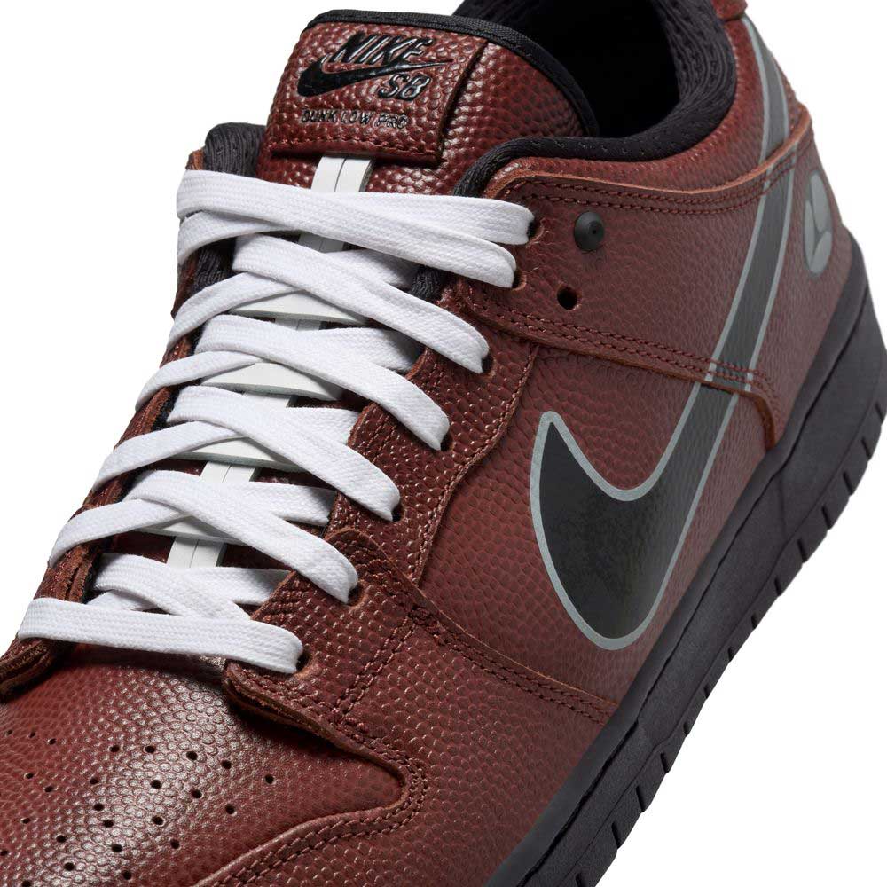 Close-up of the HJ4131-200 Limosine Dark Pony Black Silver White Nike SB Dunk Low Pro, featuring brown textured leather, white laces, a black tongue label, silver-outlined black Swoosh, black sole, and inner lining.
