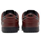 The HJ4131-200 Limosine Dark Pony Black Silver White Nike SB Dunk Low Pro Skateboarding Shoes feature brown tones and black NIKE lettering above the heel, merging classic basketball-inspired style with unique skateboard-ready details.