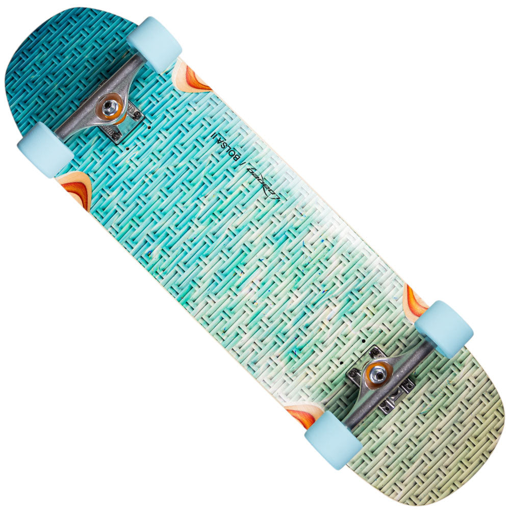The Loaded Bolsa 2 9.4x34 Complete Longboard features a teal and cream woven-pattern deck with orange and white corner accents, light blue wheels, and silver trucks—ideal for pump tracks or wave-like carving.