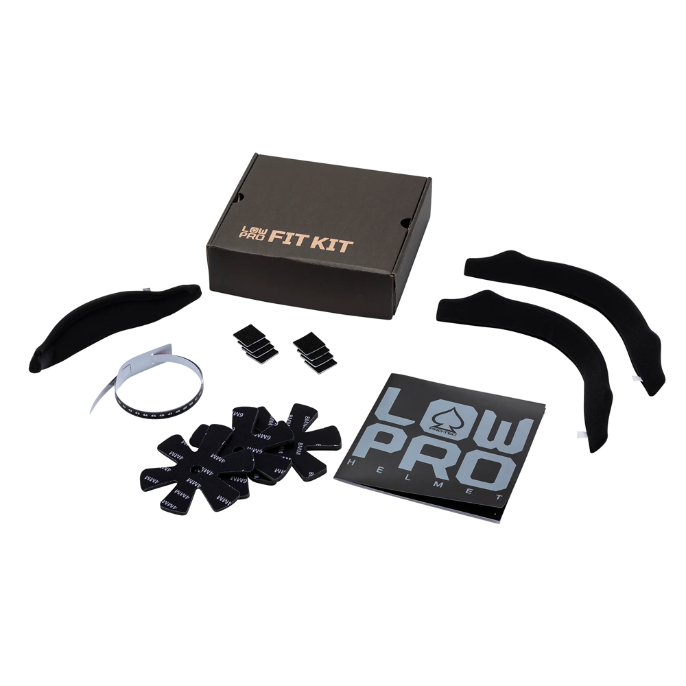 The Low Pro CPSC Protec Matte Black Helmet comes with black foam pads, adjustable straps, Velcro pieces, a sizing band, an instruction manual, and a black FIT KIT box—all neatly arranged on a white background.