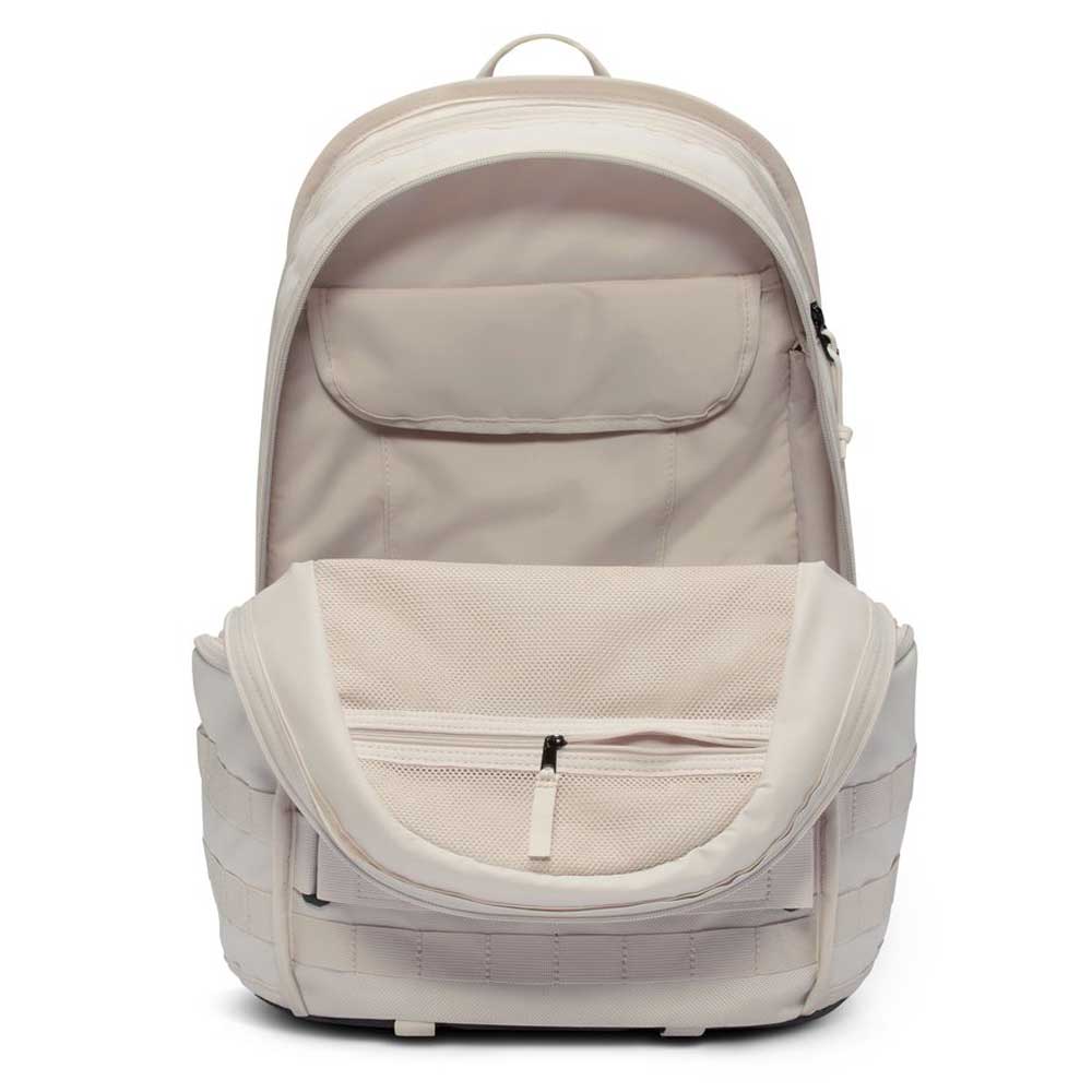 The Lt Orewood Brown Black FD7544104 Nike SB RPM Skate Backpack is shown open and empty, displaying interior pockets, a mesh zippered compartment, a laptop sleeve, organized storage sections, visible outer zippers, and a handle.