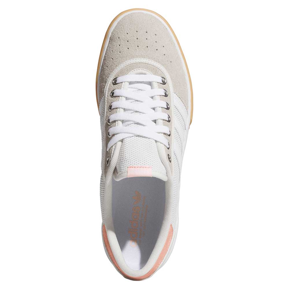 Top view of Lucas Premiere White Coral HQ7524 Adidas Skateboarding shoes, featuring white and light gray suede, coral pink heel accents, white laces, and subtle Adidas branding inside—classic skate style.