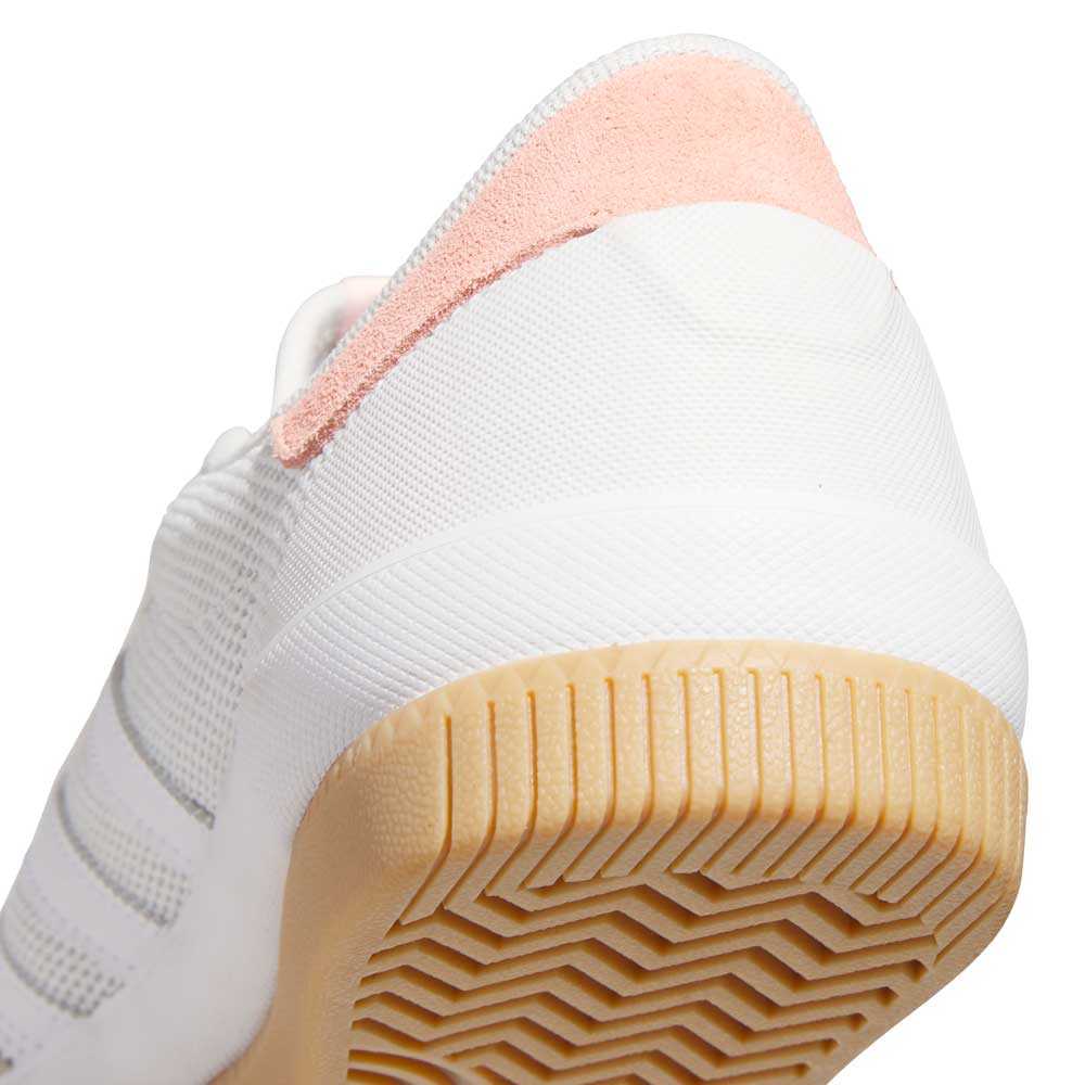 Close-up of the heel and sole of the adidas Lucas Premiere White Coral HQ7524 Skateboarding Suede Shoe, showing a coral suede heel accent and a beige rubber outsole with a unique zigzag tread pattern.