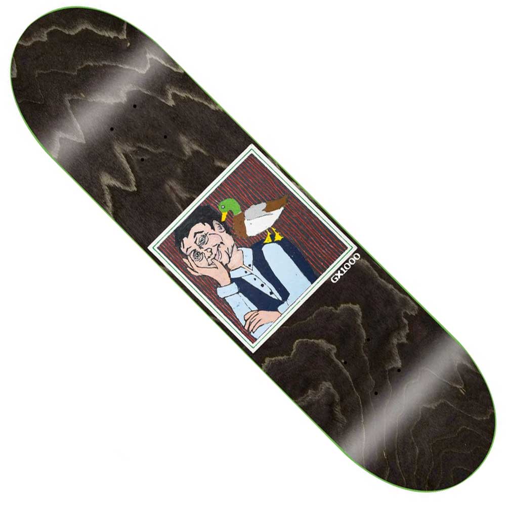 The Man with Duck 8.25x32.12 GX1000 Deck Skateboard features a black deck with a square illustration of a bored, suited man and duck on his shoulder, set on a striped red background. Made in Mexico from 100% wood.
