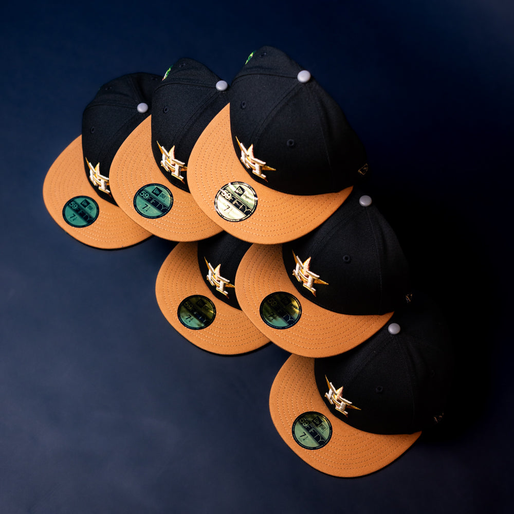 Six Midsummer Night 26 Spring Bronze Houston Astros New Era Hat 5950 Fitted caps are arranged in two columns on a dark blue surface, each featuring gold bills and green stickers on the visors.