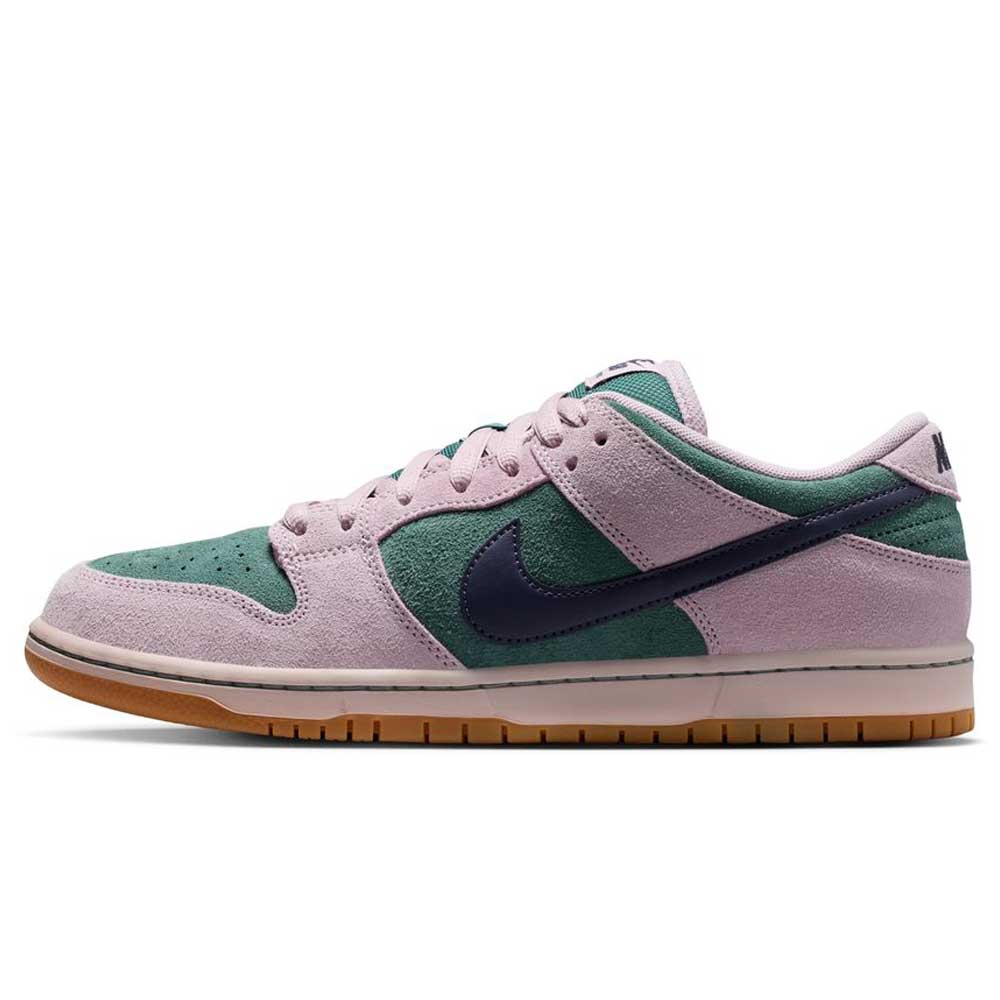 The Minereal Slate Dark Raisin Dunk Low Pro HQ1625300 Suede Skateboarding features a green suede base, light pink overlays, a dark blue Nike swoosh, white midsole, and gum rubber outsole—a fresh low-top take on classic sneakers.