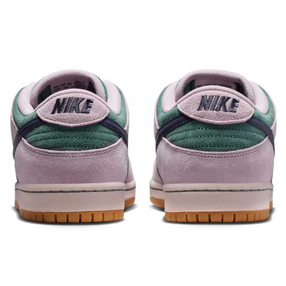 The Minereal Slate Dark Raisin Dunk Low Pro HQ1625300 Suede Skateboarding sneakers feature light purple suede, dark green heels, gum rubber soles, and black embroidered NIKE logos on the heel tabs, viewed from the back.