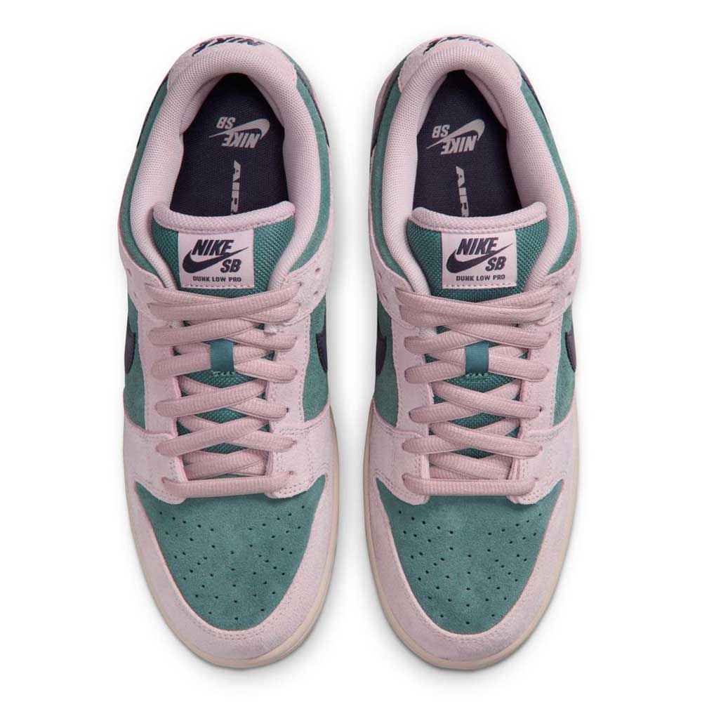 Top view of Minereal Slate Dark Raisin Dunk Low Pro HQ1625300 Suede Skateboarding sneakers in green and light pink with white midsoles, pink laces, and Nike logos on the tongue and insole, displayed side by side.