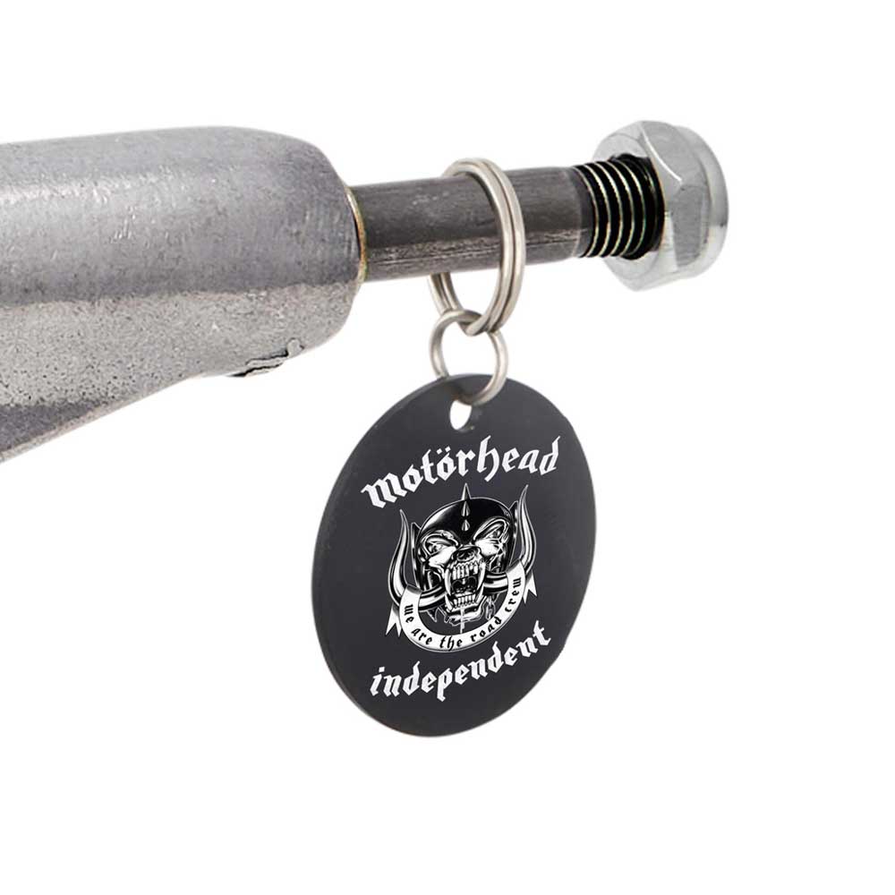 A black circular keychain with the Motörhead band logo and "independent" text hangs on a metal bolt and nut, inspired by the Motorhead Hollow Polished Silver Standard INDY 144 Stage 11 Trucks Set of TWO. It features a fanged skull with horns and chains.