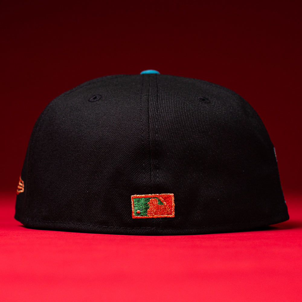 Show your Houston Astros pride with the Prisa Cero 2.0 Black Brown Houston Astros New Era Hat 5950 Fitted—a sleek black New Era baseball cap featuring a small, colorful embroidered logo on the back, set against a vibrant red surface and background. Perfect for fans seeking modern style!.