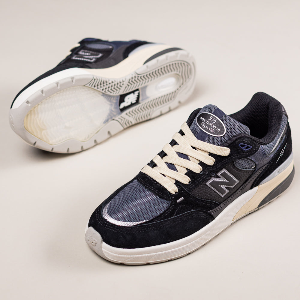 A pair of 933 BNT Andrew Reynolds New Balance Numeric Suede Skateboarding Shoes is displayed on a light background—one upright, the other on its side to show the sole and highlight their heritage skate-inspired design.