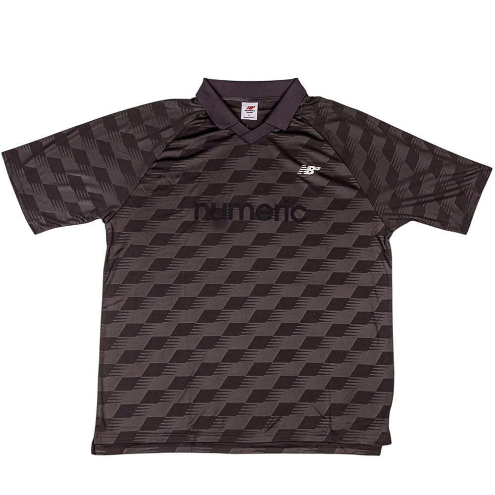 The New Balance Numeric Team Jersey MT61V471ABR is a dark, short-sleeve sports jersey with a geometric pattern, featuring the NUMARQ text and the New Balance logo on the chest.