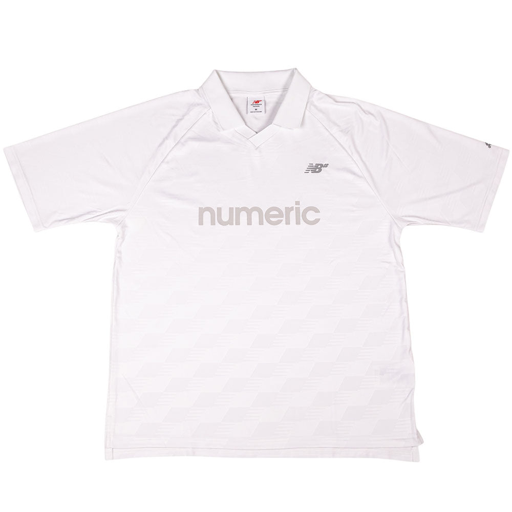 The New Balance Numeric Team Jersey MT61V471ABR is a plain white short-sleeve athletic shirt with a collar, featuring "numeric" in light gray across the chest and a small NB logo above it on the left side.