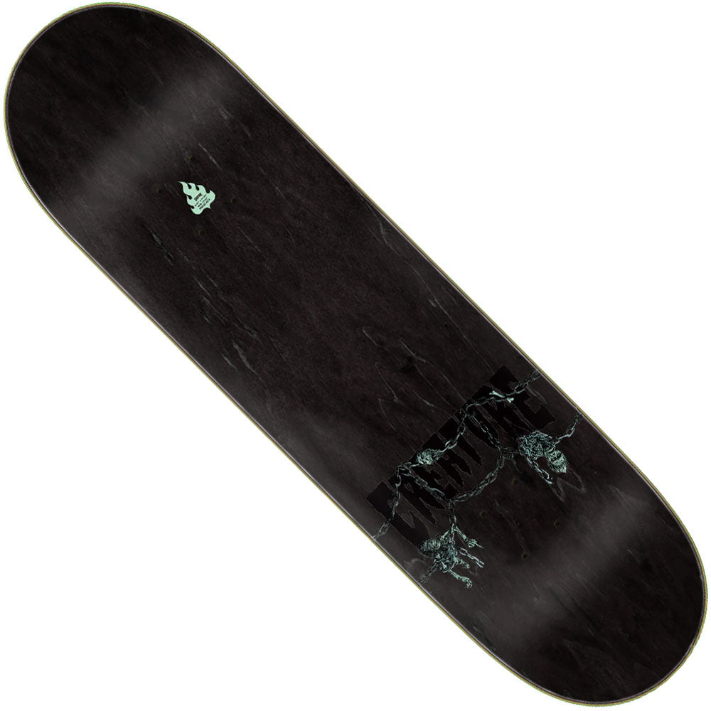 The Provost Dungeon Web Pro 8.47in x 31.98in Creature Skateboard Deck is black with a subtle marble texture, a small green tree graphic near the top, and a faint waterfall with trees image near the bottom.